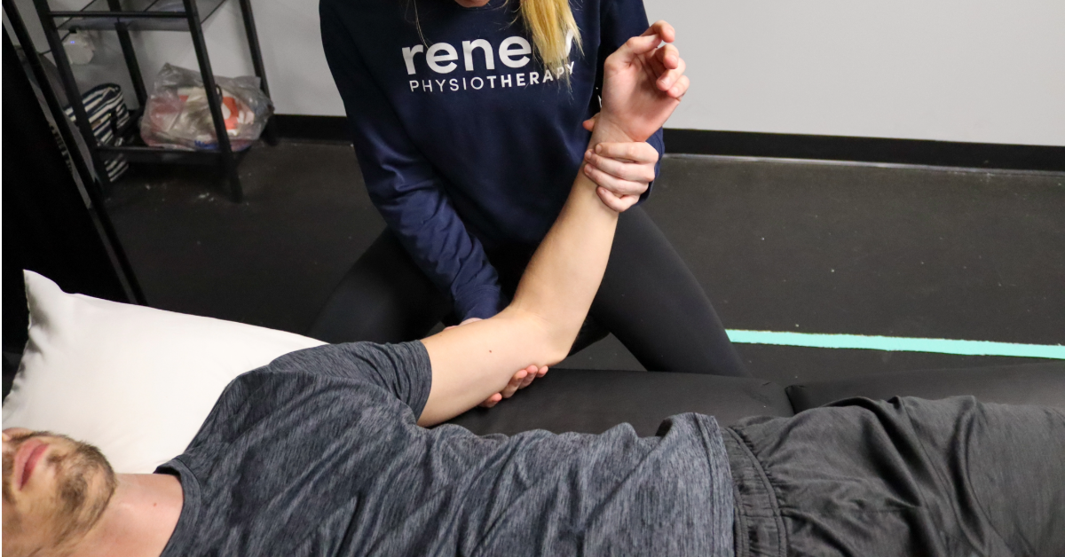 Renew Physiotherapist preforming a hands on assessment to a patients elbow