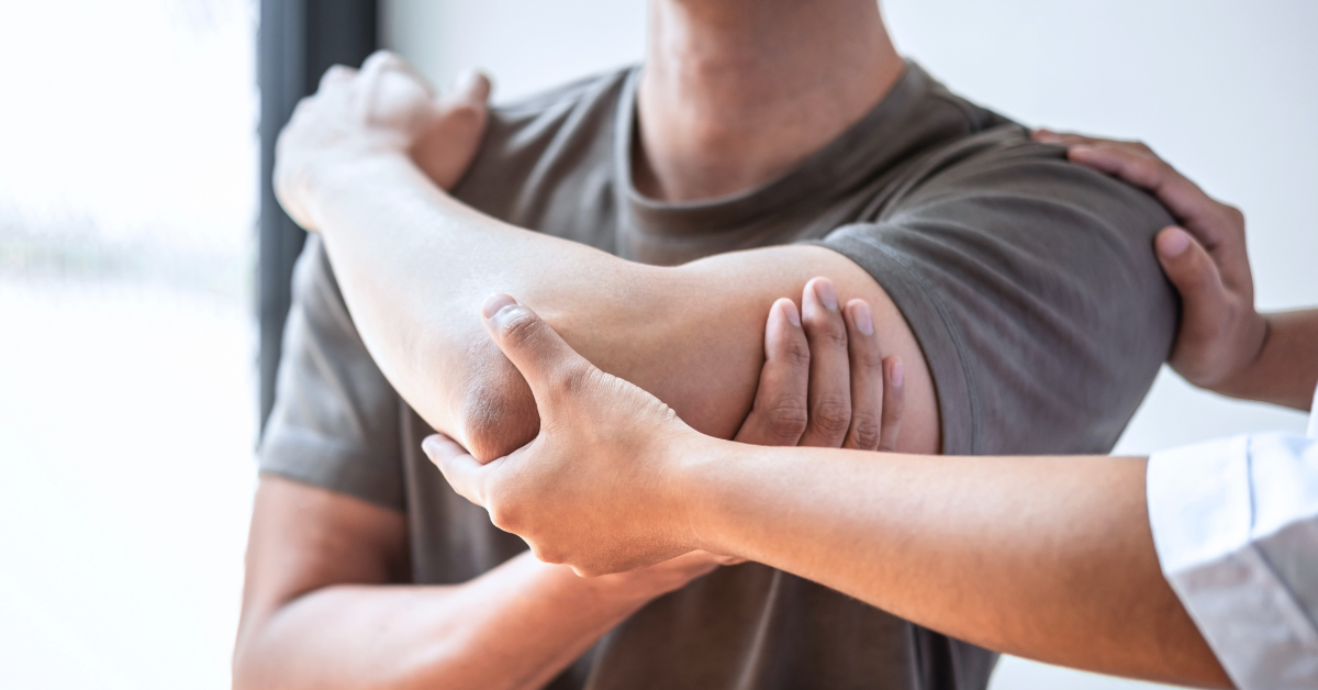 a fit man grabbing assessing shoulder mobility in physical therapy 